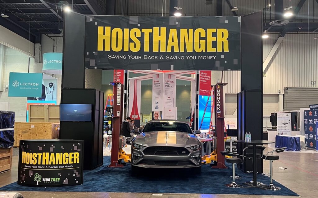 Trade show booth with suspended overhead hanging sign