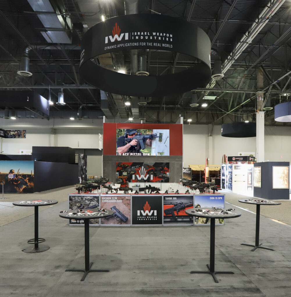 IWI trade show booth with tall backlit tower display