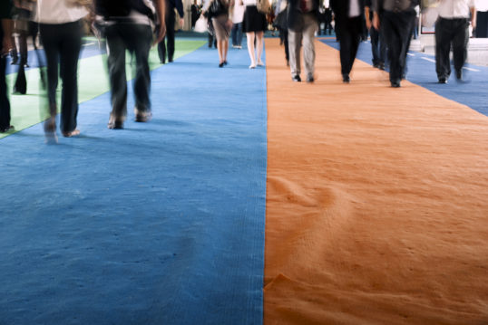 people walking on green orange and blue carpet